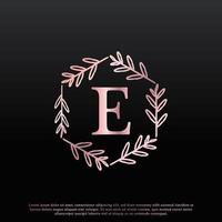 elegante logo floreale esagonale con lettera e con linea di diramazione creativa ed elegante con monogramma a foglia e colore nero rosa. utilizzabile per loghi aziendali, moda, cosmetici, spa, scienza, medicina e natura. vettore