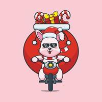 simpatico coniglietto che trasporta il regalo di natale con la moto. simpatico cartone animato di natale illustrazione. vettore
