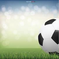 pallone da calcio sul campo di erba verde con sfondo bokeh sfocato luce. vettore. vettore