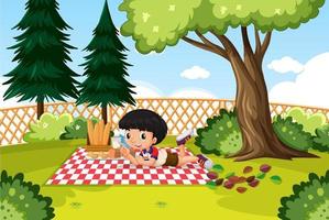 ragazzino che fa picnic in giardino vettore