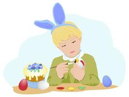 un ragazzo tedesco con benda per capelli biondi con orecchie di coniglio dipinge le uova per pasqua