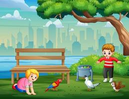 cartone animato i bambini che giocano con gli uccelli nel parco vettore