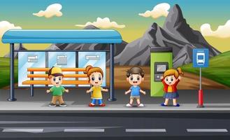 bambini felici all'illustrazione della fermata dell'autobus vettore