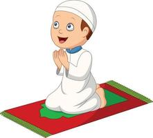 ragazzo musulmano del fumetto che prega sul tappeto di preghiera vettore