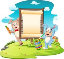 bambini felici che indossano un costume da coniglietto e dipingono le uova con lo sfondo del segno in bianco vettore