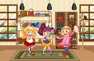 tre ragazze che ballano nel negozio di vestiti vettore