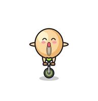 il simpatico personaggio dei fagioli di soia sta guidando una bici da circo vettore