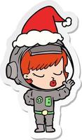 adesivo cartone animato di una bella ragazza astronauta che indossa il cappello di Babbo Natale vettore