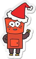 cartone animato adesivo felice di un robot che saluta con un cappello da Babbo Natale vettore