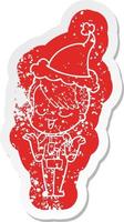 adesivo in difficoltà cartone animato felice di una ragazza in tuta spaziale che indossa il cappello da Babbo Natale vettore