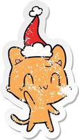 adesivo in difficoltà cartone animato di un gatto felice che indossa il cappello di Babbo Natale vettore