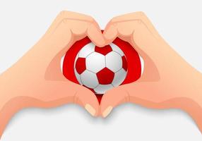 giappone pallone da calcio e mano a forma di cuore vettore