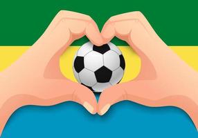 pallone da calcio del gabon e forma del cuore della mano vettore