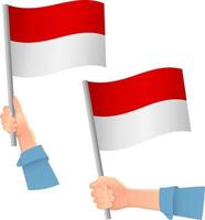 icona della bandiera dell'indonesia in mano vettore