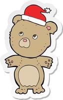 adesivo di un orso cartone animato con cappello di Natale vettore