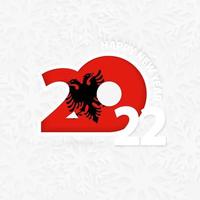 felice anno nuovo 2022 per l'albania sullo sfondo del fiocco di neve. vettore